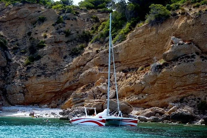 Sailing catamaran with small group under sail off the north coast of Menorca near Fornells on a half-day marine reserve cruise